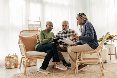 Senior couple signing a contract | Hicks-Guinn Law Firm